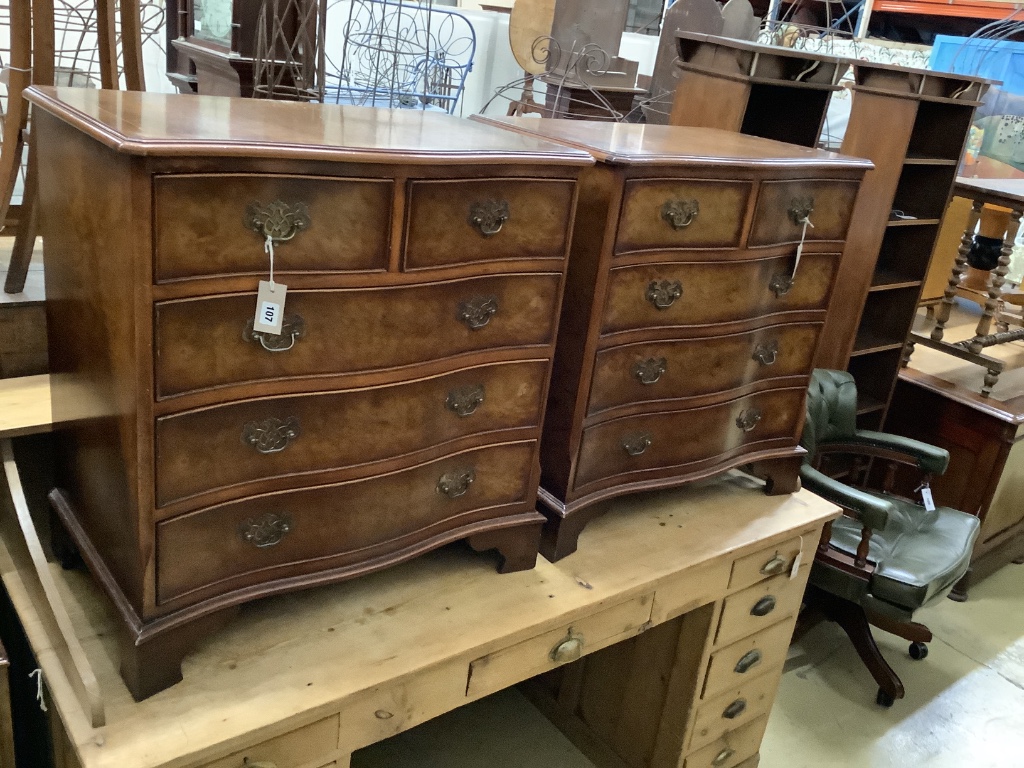 A pair of Georgian style walnut serpentine-fronted chests of drawers, of small proportions, each fitted two short drawers and three long drawers, on bracket feet, width 74cm, depth 46cm, height 78cm W 74cm